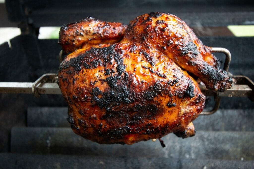 chicken on a spit rotisserie cooking method