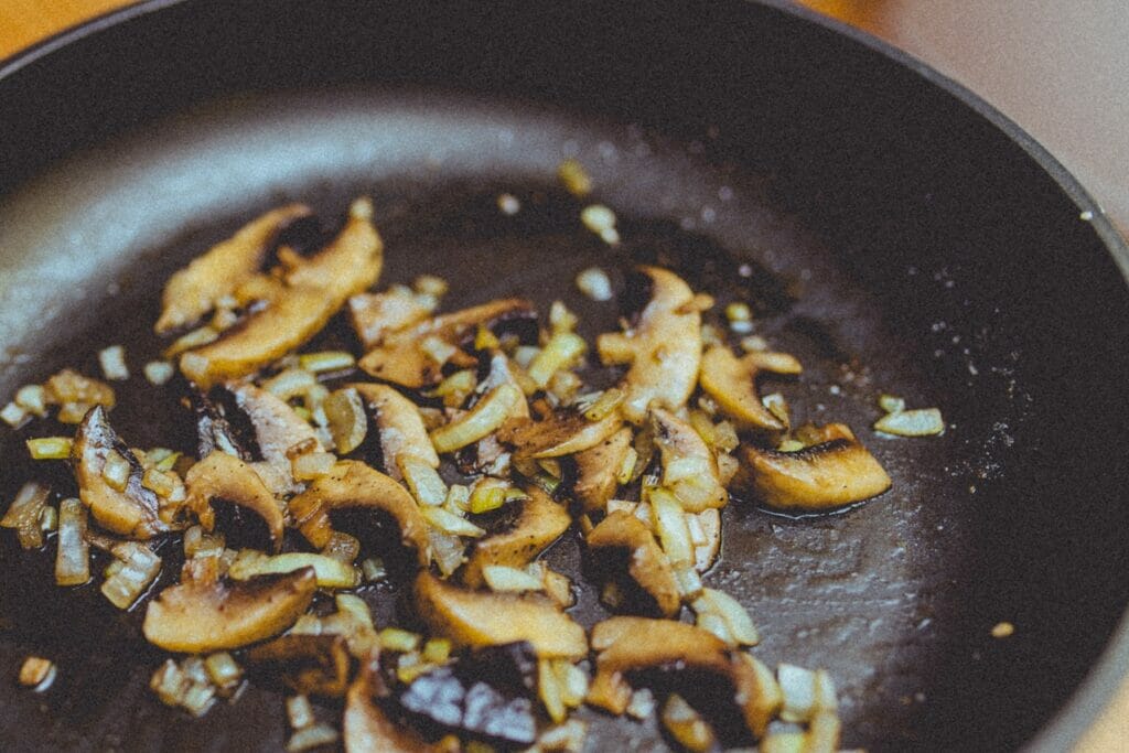 sauteing mushrooms in a pan cooking method