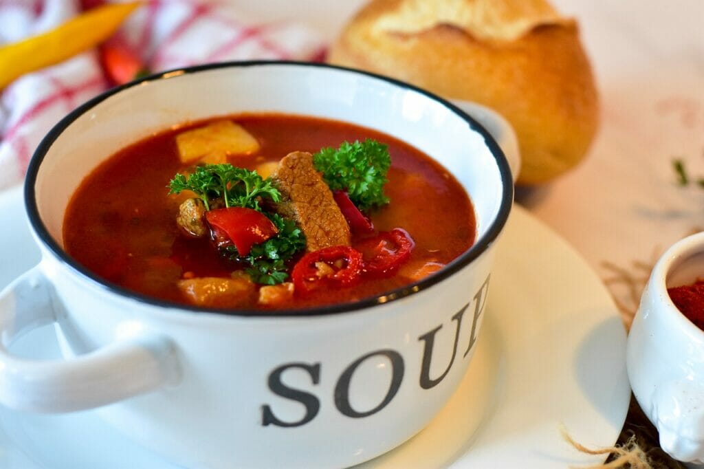 stewing goulash cooking methods in a white pan